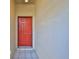 Red front door entry into the home with tiled flooring at 633 Tremont Greens Ln # 16, Sun City Center, FL 33573