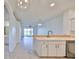 Kitchen with breakfast bar and view into living room at 633 Tremont Greens Ln # 16, Sun City Center, FL 33573