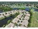 Aerial view showing the community near a golf course and lake at 633 Tremont Greens Ln # 16, Sun City Center, FL 33573