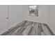Small bedroom with grey wood-look floors and a window at 633 Tremont Greens Ln # 16, Sun City Center, FL 33573