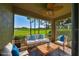 Virtually staged porch with golf course view, comfy seating at 633 Tremont Greens Ln # 16, Sun City Center, FL 33573
