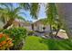 Front view of house with walkway, landscaping, and a two-car garage at 633 Tremont Greens Ln # 16, Sun City Center, FL 33573