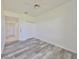 Bright bedroom with grey wood-look floors and double door closet at 633 Tremont Greens Ln # 16, Sun City Center, FL 33573
