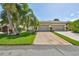 Well-maintained house with a two-car garage and lush landscaping at 633 Tremont Greens Ln # 16, Sun City Center, FL 33573