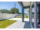 Comfortable back patio opens to a lush, fenced yard with a block retaining wall at 7422 S 34Th Ave, Tampa, FL 33619