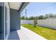Backyard features a pristine white fence, healthy lawn and freshly poured patio at 7422 S 34Th Ave, Tampa, FL 33619