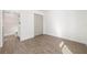 Bedroom with wood look floors, closet, and nearby full bath at 7422 S 34Th Ave, Tampa, FL 33619