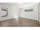 Bright bedroom with new floors and two windows bringing in natural light at 7422 S 34Th Ave, Tampa, FL 33619