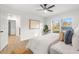 Bright bedroom features new paint, wood-look floors, and a ceiling fan at 7422 S 34Th Ave, Tampa, FL 33619