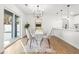 Bright dining area with glass table, stylish chandelier, and sliding glass door at 7422 S 34Th Ave, Tampa, FL 33619