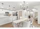 Open concept dining area with modern chandelier and adjacent kitchen at 7422 S 34Th Ave, Tampa, FL 33619