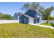 Two-story home boasts a private fenced yard, manicured lawn and attached one-car garage at 7422 S 34Th Ave, Tampa, FL 33619