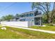 Two-story home boasts a private fenced yard, mature trees and a manicured lawn at 7422 S 34Th Ave, Tampa, FL 33619