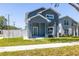 Gorgeous two-story home with manicured lawn, mature tree and white picket fence at 7422 S 34Th Ave, Tampa, FL 33619