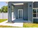 Inviting entryway with a modern blue door and stylish outdoor lighting at 7422 S 34Th Ave, Tampa, FL 33619
