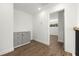 Hallway with wood floors, storage cabinet, and natural light at 7422 S 34Th Ave, Tampa, FL 33619