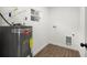 Bright utility room features modern water heater, washer and dryer hookups, and wood-look floors at 7422 S 34Th Ave, Tampa, FL 33619