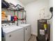 Functional laundry room with washer, dryer, and storage shelving at 3715 E Clifton St, Tampa, FL 33610