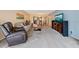 Living room with comfortable seating and view into dining area at 2285 Israeli Dr # 29, Clearwater, FL 33763