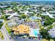 Aerial view of community featuring pool, tennis courts, and numerous buildings at 2285 Israeli Dr # 29, Clearwater, FL 33763
