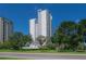 High-rise building with lush landscaping and street view at 4141 Bayshore Blvd # 1003, Tampa, FL 33611