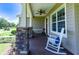 Relaxing front porch with a rocking chair and ceiling fan at 36431 Florrie Mae Ln, Dade City, FL 33523