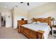 Well-lit bedroom with a king-size bed, walk-in closet, and wooden dresser at 36431 Florrie Mae Ln, Dade City, FL 33523