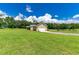 View of home's garage and side yard at 36431 Florrie Mae Ln, Dade City, FL 33523