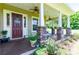 Charming front door entry with a welcome sign and potted plants at 36431 Florrie Mae Ln, Dade City, FL 33523
