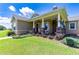 Inviting front porch with rocking chairs and stone pillars at 36431 Florrie Mae Ln, Dade City, FL 33523