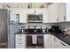 Updated kitchen with stainless steel appliances and dark countertops at 36431 Florrie Mae Ln, Dade City, FL 33523