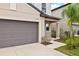 Brown garage door with walkway and landscaping at 5070 White Chicory Dr, Apollo Beach, FL 33572