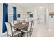 Dining area with a dark wood table and blue curtains at 5070 White Chicory Dr, Apollo Beach, FL 33572