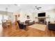 Open concept living room with a stone fireplace and hardwood floors at 36431 Florrie Mae Ln, Dade City, FL 33523