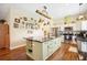 Modern kitchen with large island, granite countertops and upgraded cabinets at 36431 Florrie Mae Ln, Dade City, FL 33523