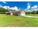View of home's garage and side yard at 36431 Florrie Mae Ln, Dade City, FL 33523