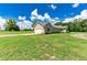 View of the home's garage and side yard at 36431 Florrie Mae Ln, Dade City, FL 33523