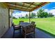 Covered patio with outdoor dining set, offering a relaxing space at 36431 Florrie Mae Ln, Dade City, FL 33523