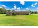 Ranch style home exterior with a large backyard at 36431 Florrie Mae Ln, Dade City, FL 33523