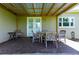 Covered patio with seating area and double doors at 36431 Florrie Mae Ln, Dade City, FL 33523