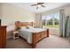Spacious bedroom with large window, wooden furniture, and carpeted floor at 36431 Florrie Mae Ln, Dade City, FL 33523