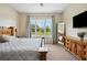 Bright bedroom featuring a king-size bed, large window, and ample natural light at 36431 Florrie Mae Ln, Dade City, FL 33523