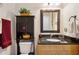 Bathroom with granite countertop, wood cabinets, and a large mirror at 36431 Florrie Mae Ln, Dade City, FL 33523