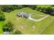 Aerial view of a ranch-style home with a long driveway and ample green space at 36431 Florrie Mae Ln, Dade City, FL 33523