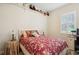 Bright bedroom with a comfortable bed, window shutters, and built-in shelving at 36431 Florrie Mae Ln, Dade City, FL 33523
