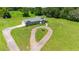 Aerial view of a home with a heart-shaped driveway and surrounding green space at 36431 Florrie Mae Ln, Dade City, FL 33523