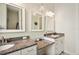 Bathroom with double vanity, granite countertop, and large mirrors at 36431 Florrie Mae Ln, Dade City, FL 33523
