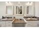 Elegant bathroom with double vanity, granite countertop, and large mirrors at 36431 Florrie Mae Ln, Dade City, FL 33523