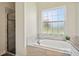 Bathroom with a soaking tub, shower, and granite countertops at 36431 Florrie Mae Ln, Dade City, FL 33523
