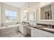 Spa-like bathroom featuring a soaking tub, double vanity, and granite countertops at 36431 Florrie Mae Ln, Dade City, FL 33523